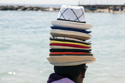 Rear view of vendor wearing hats