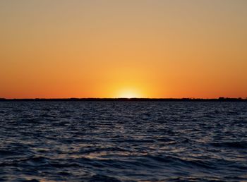 Scenic view of sea against clear sky during sunset