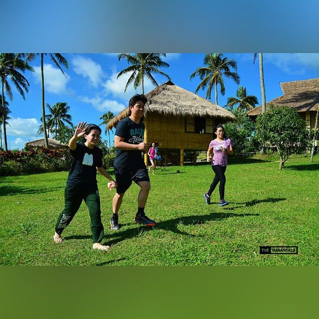 grass, lifestyles, leisure activity, full length, casual clothing, field, green color, childhood, boys, girls, tree, togetherness, sky, grassy, enjoyment, person, playing, standing