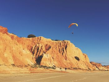 Scenic view of desert against clear blue sky