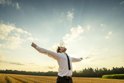 Man standing on field against sky