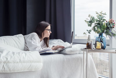 Man sitting on bed at home