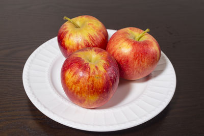 High angle view of apples in plate on table