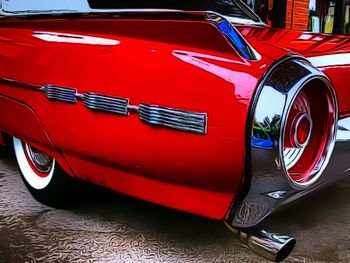 Close-up of red car on road