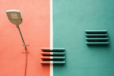 Close-up of street light on colored wall