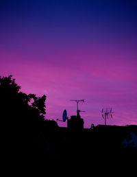 Low angle view of built structure against sky at sunset