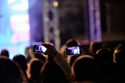 Group of people using smart phone at music concert