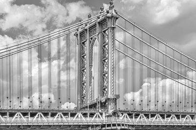 Suspension bridge against sky in city