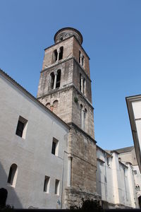 Low angle view of historic building against clear blue sky