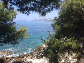 Scenic view of sea with mountain in background