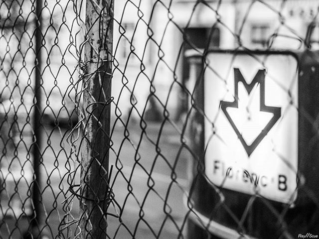 text, communication, western script, focus on foreground, close-up, safety, protection, security, sign, day, metal, guidance, building exterior, no people, built structure, information sign, outdoors, architecture, fence, chainlink fence