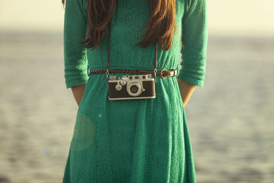 Rear view of woman standing on beach