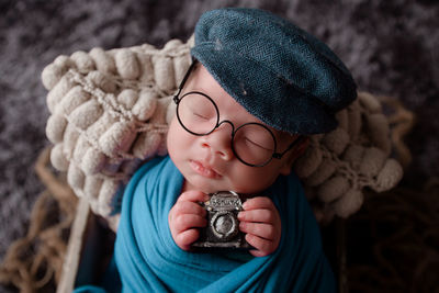 Close-up of cute boy holding hat