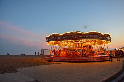 People at amusement park ride at dusk