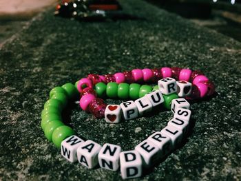 Close-up of multi colored bracelets on concrete