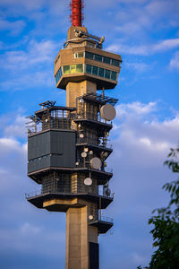 Low angle view of building against sky industrial tower