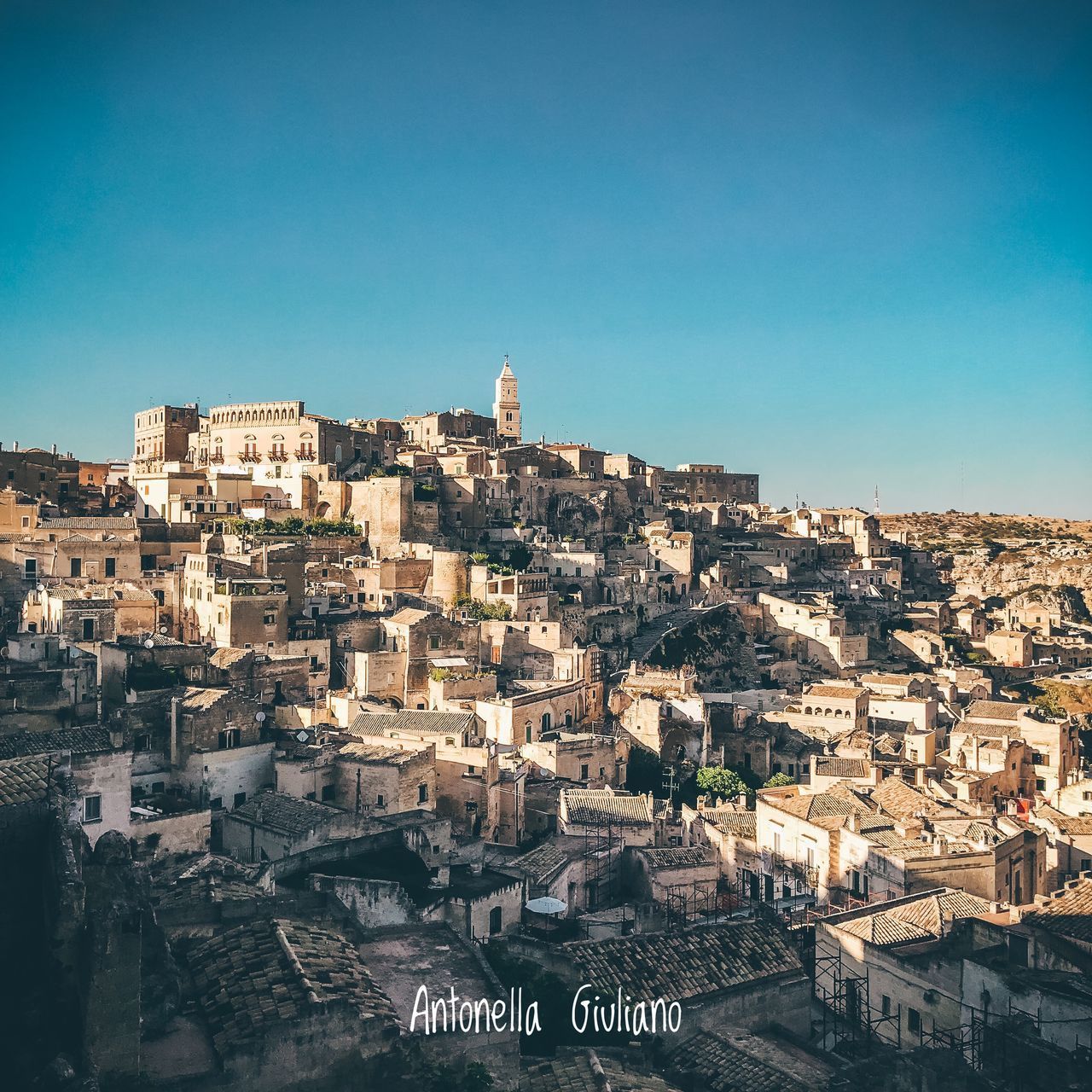 AERIAL VIEW OF TOWNSCAPE AGAINST BLUE SKY