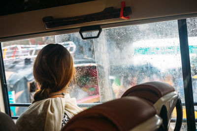 Rear view of woman traveling in bus