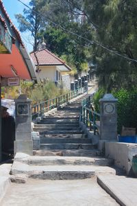 Steps leading towards temple against sky