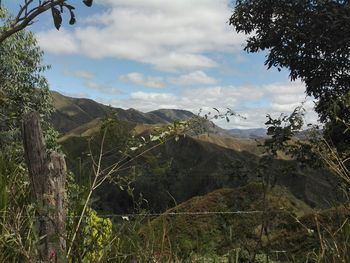 Scenic view of mountains against cloudy sky