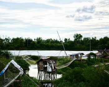 Scenic view of lake by building against sky