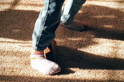 Low section of person standing on carpet