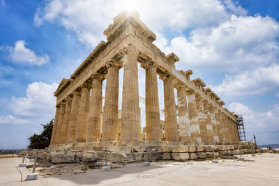 Low angle view of historical building against cloudy sky