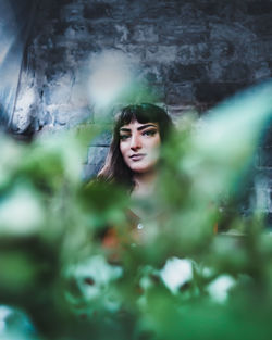 Portrait of beautiful woman against blurred background