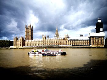 Boat in river with city in background