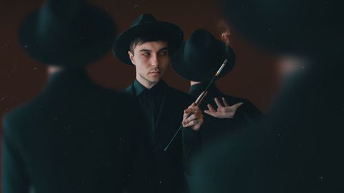 Portrait of young man holding camera