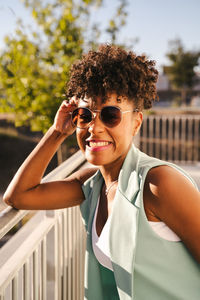 Portrait of young woman wearing sunglasses standing outdoors