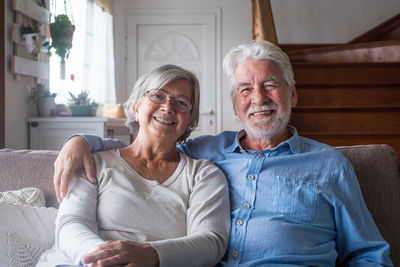Portrait of happy friends sitting on floor