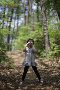 Portrait of girl standing in forest