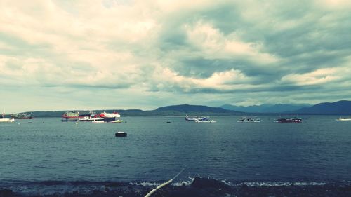 Sailboats on sea against sky