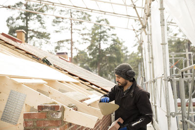 Bricklayer working on construction site