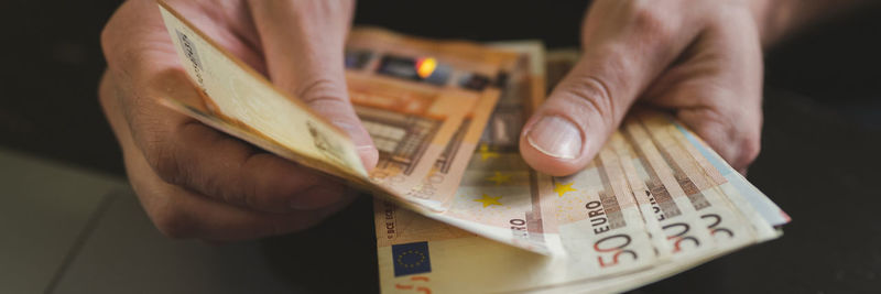 Business man counting money. male hands holds and count cash banknotes euros bills or notes currency