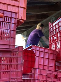 Red crates against men