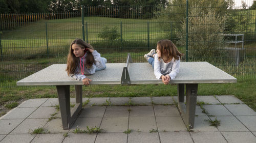 Full length of woman sitting on bench