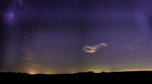 Silhouette landscape against starry sky