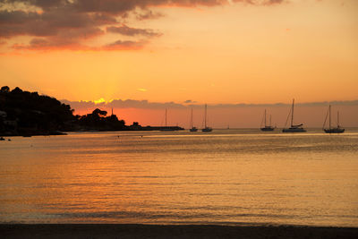 Scenic view of sea against orange sky