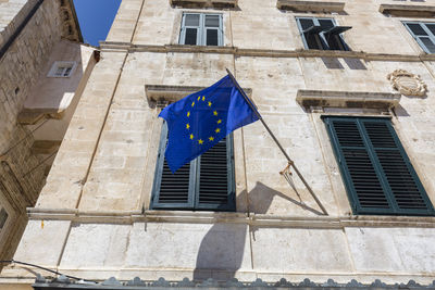 Low angle view of flag against building