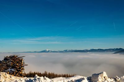 Scenic view of snowcapped mountains against blue sky