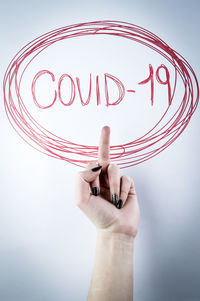 Midsection of person holding paper against white background