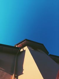 Low angle view of built structure against clear blue sky