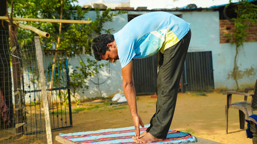 Young man doing yoga outdoors with amazing background.