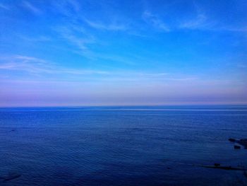 Scenic view of sea against blue sky