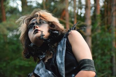 Woman looking away in forest