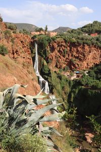 Scenic view of waterfall against sky