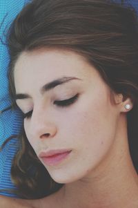 Close-up of teenage girl sleeping on bed at home