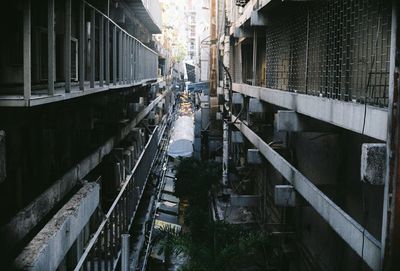 High angle view of narrow alley amidst buildings in city